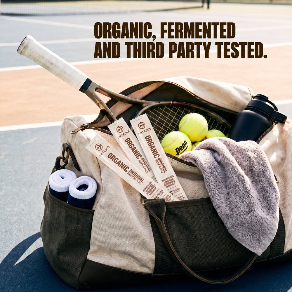 Three Organic Original Beef Sticks tucked in a tennis bag on the court, under the line Organic, fermented and third party tested.